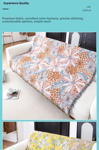 Close-up of jacquard woven floral throw blanket with elegant fringe edges on white sofa