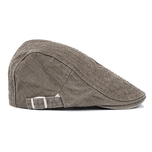 Detail of grey cotton flat cap showing fabric texture and adjustable silver metal buckle