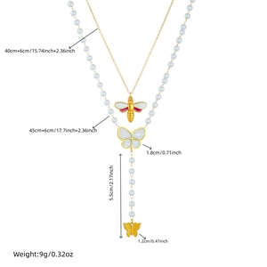 Layered gold chain necklace with butterfly, bee pendants and elegant pearl tassel