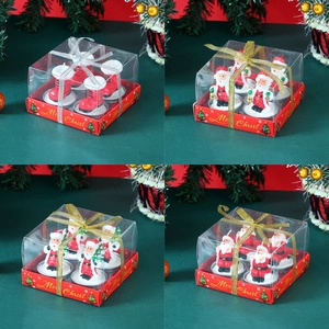 Detailed view of Christmas candle set featuring Santa and boot shapes in gift boxes