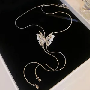Elegant adjustable silver butterfly tassel necklace with layered wings on black velvet
