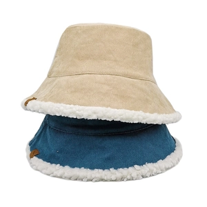 Thick warm corduroy bucket hat for women with white faux lamb wool lining in cream and navy