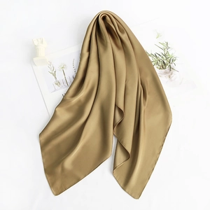 Close-up of elegant olive green satin square scarf with silky texture and soft drapes