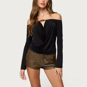 Close-up of beaded cowl neck off-shoulder top with a central bead and bronze grommet shorts