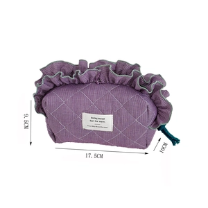 Detail showing dimensions of purple quilted checkered bag with ruffles and tassel