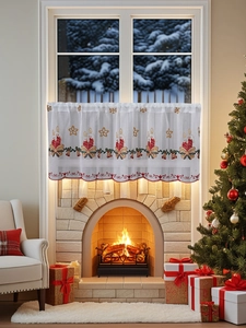 Detail of Christmas cafe curtain featuring festive embroidery on white sheer fabric