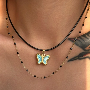 Vintage 18k gold plated butterfly pendant with blue enamel on a black cord necklace