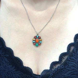 Bohemian style necklace with a sunburst gemstone pendant featuring colorful inlaid stones