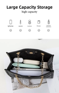 Macro view of spacious interior storage for quilted crossbody bag with golden chain