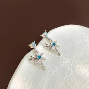 Detail of silver fairy earrings with heart opal stone and blue zircon on a tray