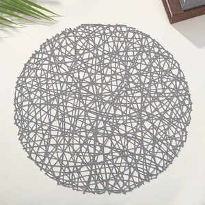 Modern grey round PVC cutout placemat with hollow mesh design for home dining table