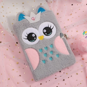 Detailed view of plush owl diary with silver lock on pink sparkling tulle background
