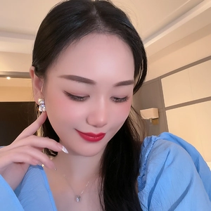 Close-up of model wearing square zircon earrings and a minimalist solitaire necklace