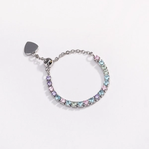 Detail of adjustable silver ring with colorful cubic zirconia and heart pendant charm