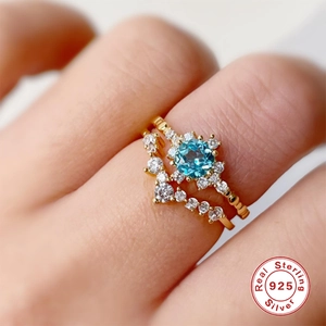 Luxury S925 sterling silver snowflake ring set with sea blue zircon and gold plating