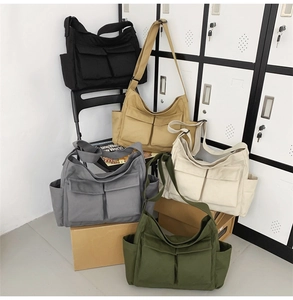 Detail showing five colors of durable canvas crossbody bags with adjustable straps
