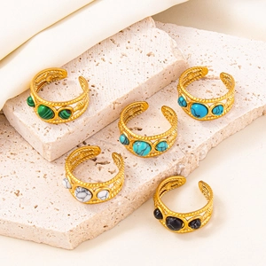 Detailed top view of five adjustable gold rings featuring colorful marble stone inlays