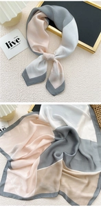 Detail of elegant geometric patchwork silk scarf with satin finish and pastel colors