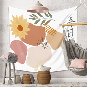 Detail of sunflower tapestry with geometric shapes hung in a cozy Nordic style room