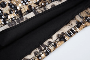 Macro shot of leopard print fabric with silver sequins and black knit lining detail