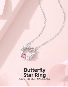Macro shot of S925 silver necklace with pink gemstone pendant and butterfly star details