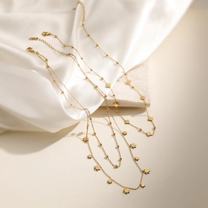 Elegant 18K gold plated stainless steel necklace with star pendant on white silk