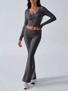 Detail of dark grey long sleeve V-neck crop top and high waist flared trousers set