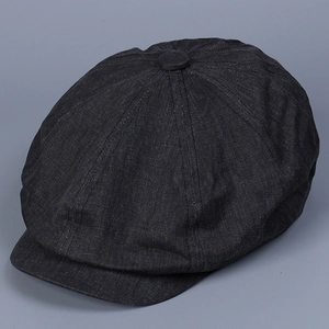 Detailed side view of black cotton twill newsboy cap with classic paneled design