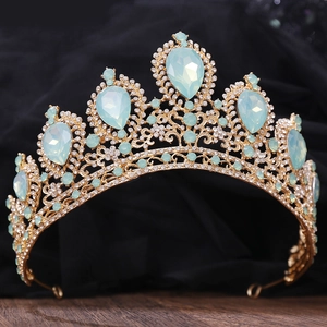 Close-up of golden bridal crown with pear-shaped light blue gems and sparkly rhinestones