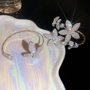 Detailed macro view of silver flower and butterfly bracelet with sparkling zircon stones