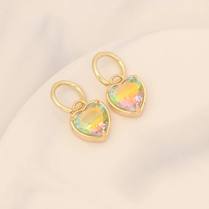 Close-up of heart-shaped earrings with 18K gold plating and iridescent crystal texture