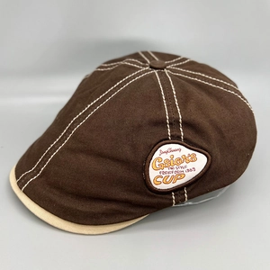 Vintage dark brown cotton beret hat with white contrast stitching and a side logo patch