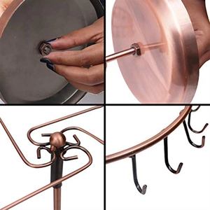 Detail of rotating jewelry rack assembly with metal base and black hanging hooks