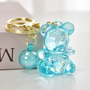 Transparent blue candy bear acrylic keychain with golden ring and blue ball charm