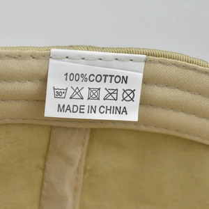 Close-up of the 100% cotton washing label and care instructions inside the flag baseball cap