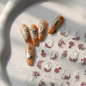 Close-up of White Swan embossed nail art stickers with 3D floral and pearl details