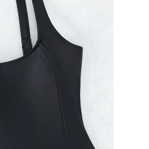 Detail showing high-elasticity quick-dry fabric and tight stitching on black swimsuit