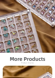 Macro shot of iridescent aurora crystal nail art charms in a clear acrylic storage box
