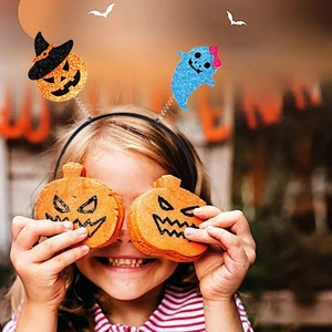 Halloween headband featuring sequined spring pumpkin and blue ghost on a young girl