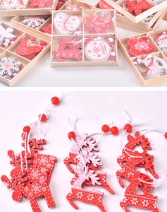 Detailed view of red wooden reindeer ornaments with Merry Christmas engraving and white cords