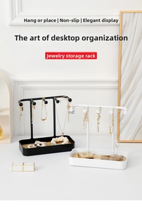 Detailed close-up of a metal jewelry organizer with a wood base for rings and necklaces