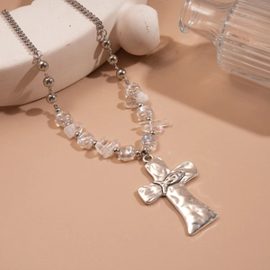 Detail of silver bead chain and iridescent beads with textured cross and fish symbol