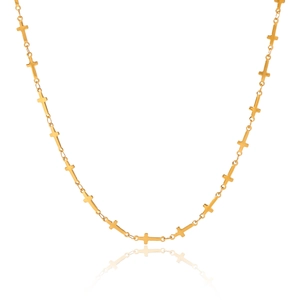 Detail of a gold stainless steel chain featuring small minimalist cross link pendants