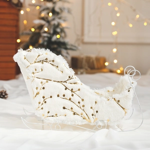 Christmas reindeer sleigh ornament with white plush and gold print on festive background