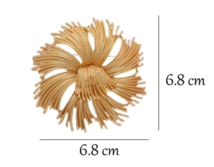 Detailed view of gold flower brooch with 6.8cm size measurement on white background