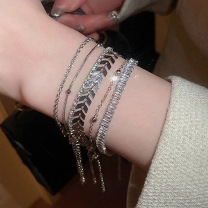 Five-piece silver zircon bracelet set featuring snake and rope chains on a wrist