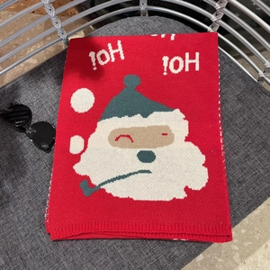 Close-up of red Christmas scarf featuring Santa Claus jacquard and HO! HO! text detail