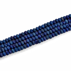 Macro detail of blue geode agate rondelle beads showing natural stone textures
