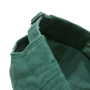 Detailed close-up of dark green cotton baseball cap showing back metal buckle and stitching