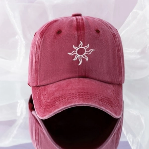 Close-up of vintage burgundy washed denim baseball cap with white sun flower embroidery